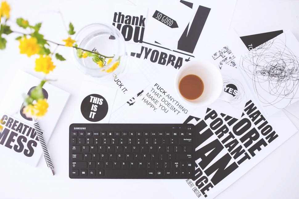 Free Image of Computer Keyboard on Table Beside Coffee Cup 
