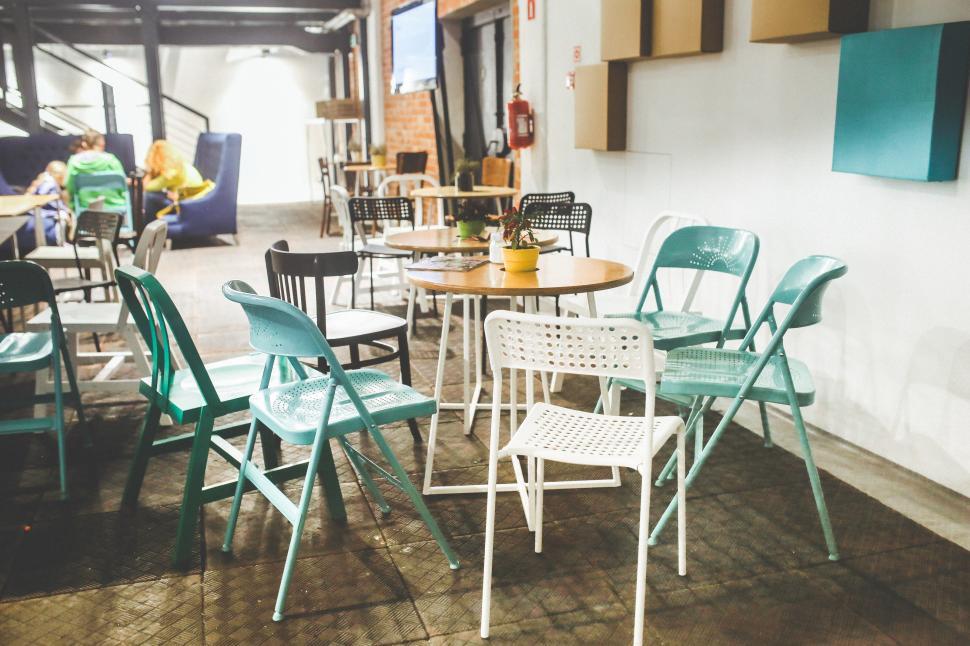Free Image of Group of Tables and Chairs Arranged Together 