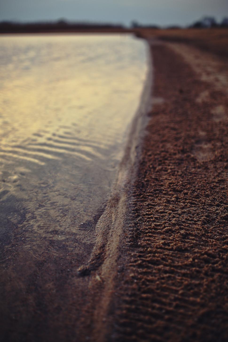 Free Image of Sandy Beach by Water 