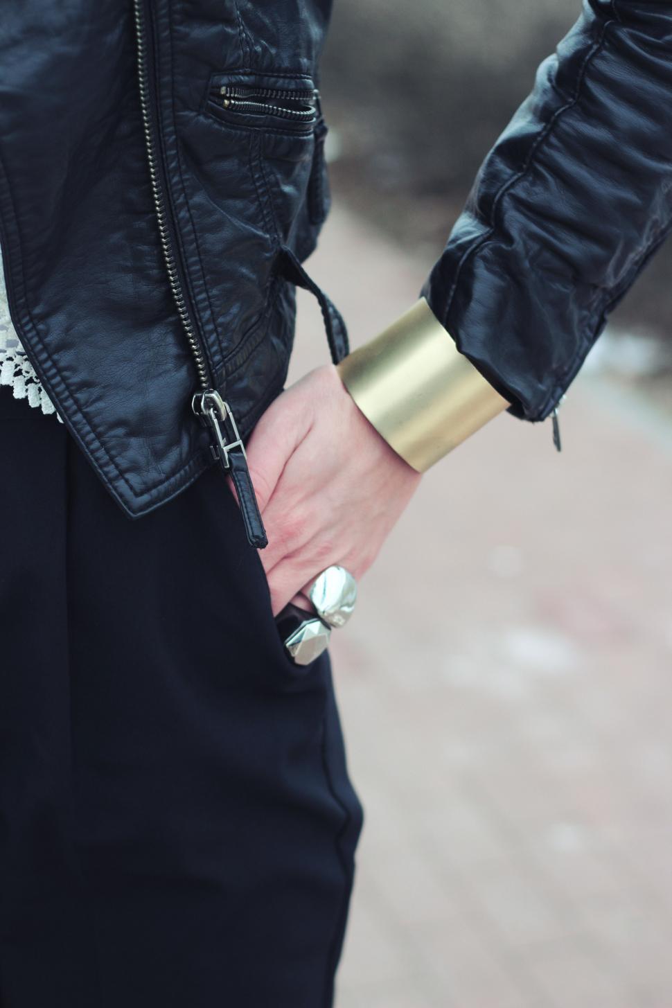 Free Image of Man in Black Jacket Holding Onto Wrist 