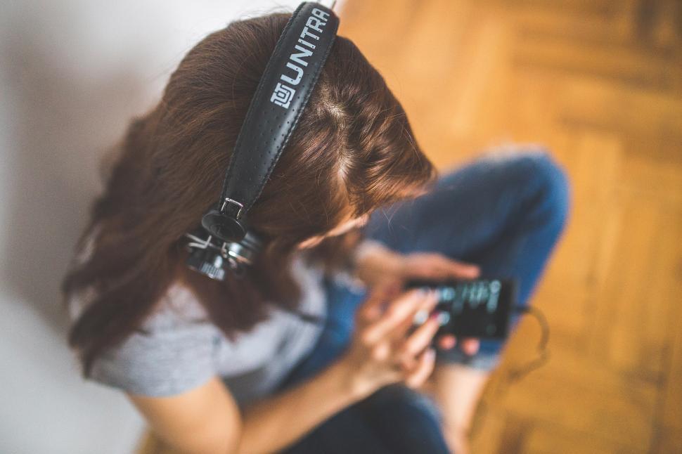 Free Image of Woman Sitting on Floor With Camera 