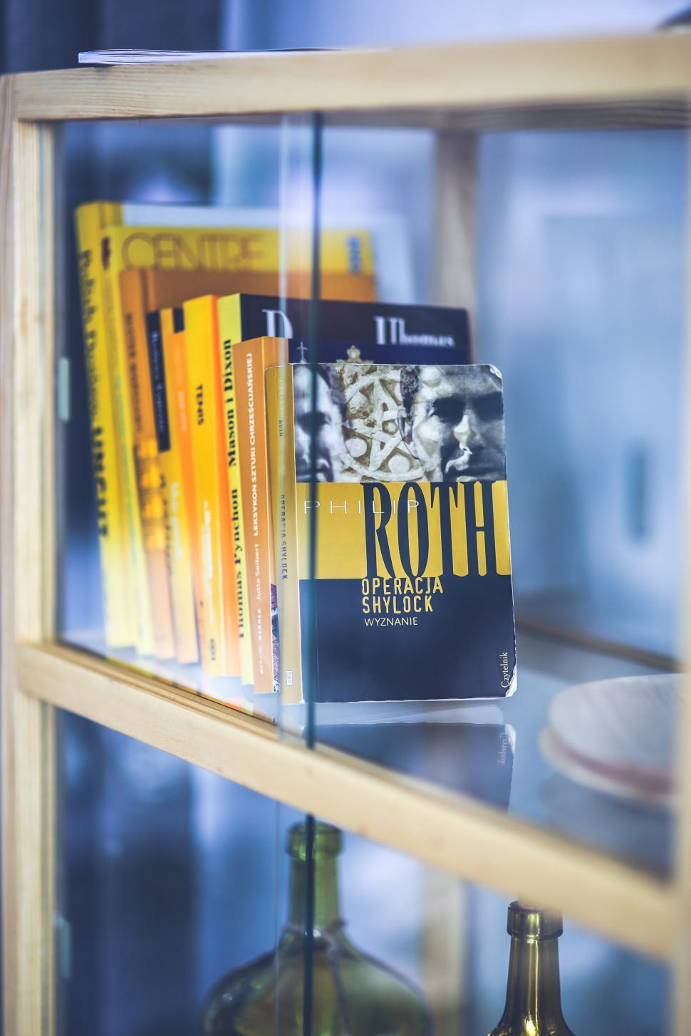 Free Image of Shelf With Books and Bottle 