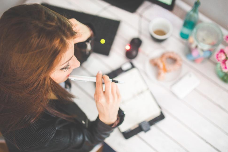 Free Image of Woman Smoking Cigarette at Desk 