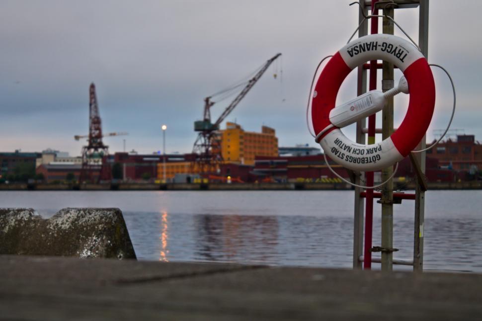 Free Image of Life buoy in harbour. Rescue ring in harbour at night. Concept of safety against drowning accidents.  