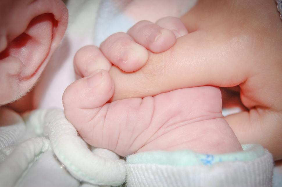 Free Image of Person Holding Baby Up Close 