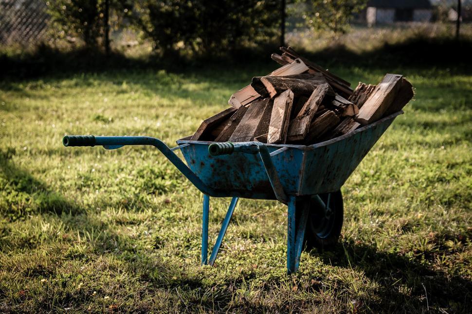 Free Image of Wheelbarrow Full of Wood in Yard 