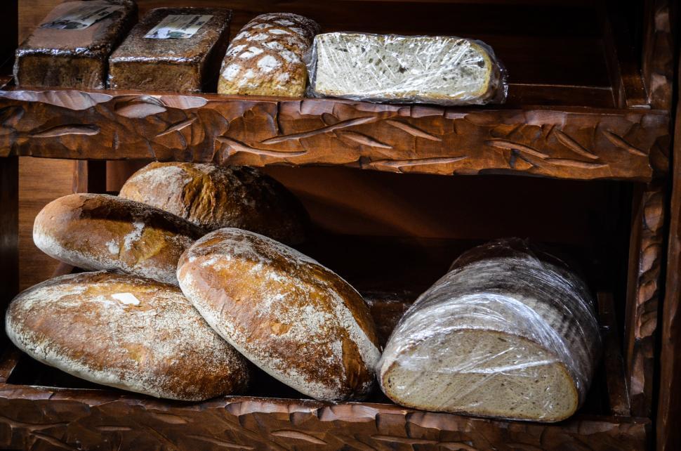 Free Image of Wooden Shelf Filled With Loaves of Bread 