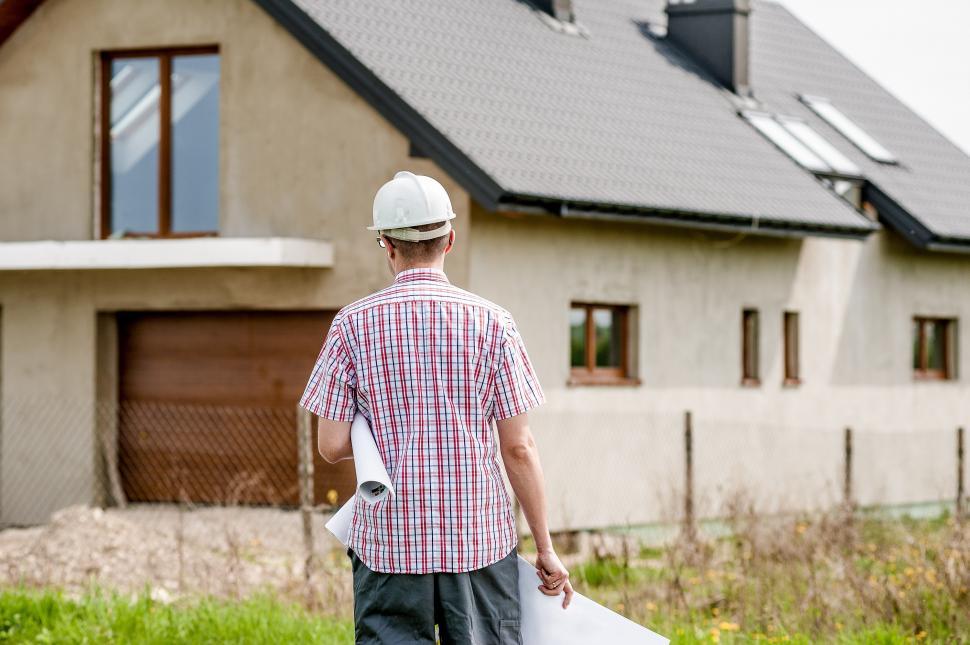 Free Image of Man in Hardhat Approaching House 