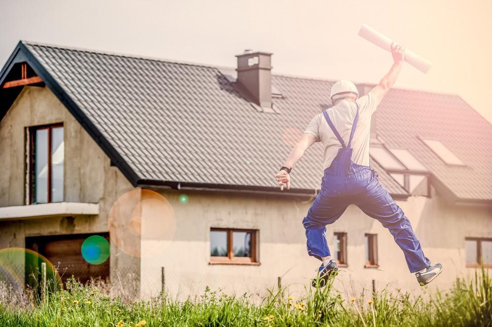 Free Image of Man Holding Baseball Bat in Front of House 