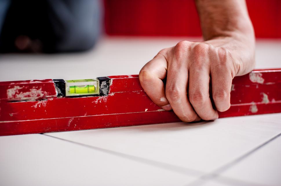 Free Image of Person Holding Piece of Tape on Table 