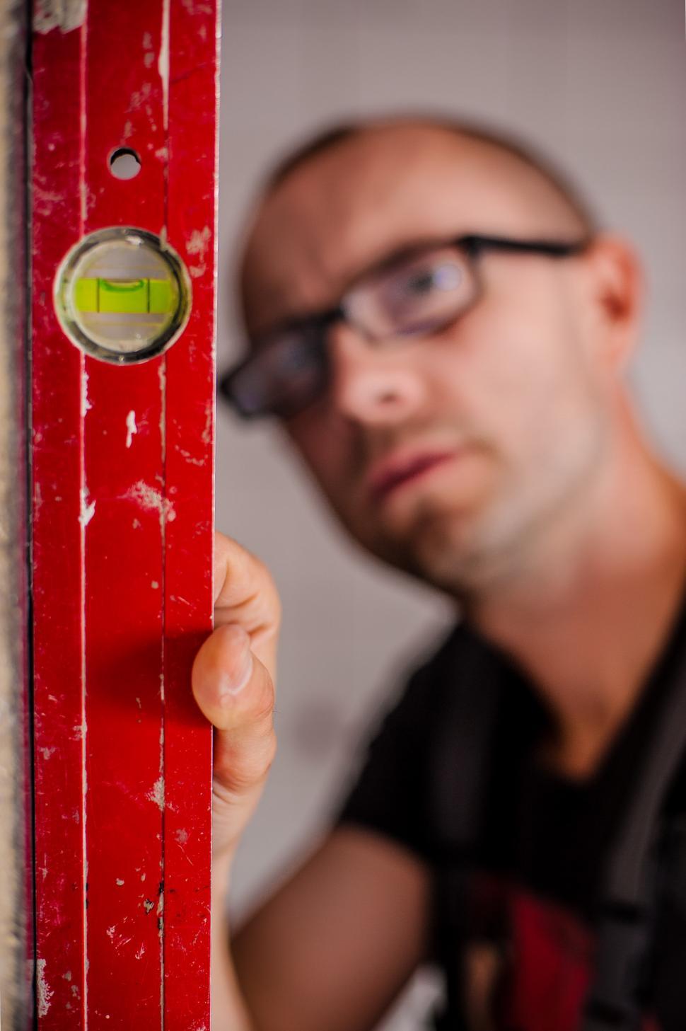 Free Image of Man Holding Red Door Handle 