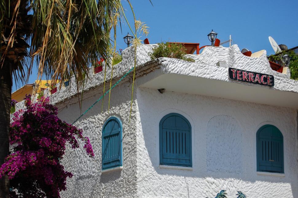 Free Image of White Building With Blue Shutters and Windows 
