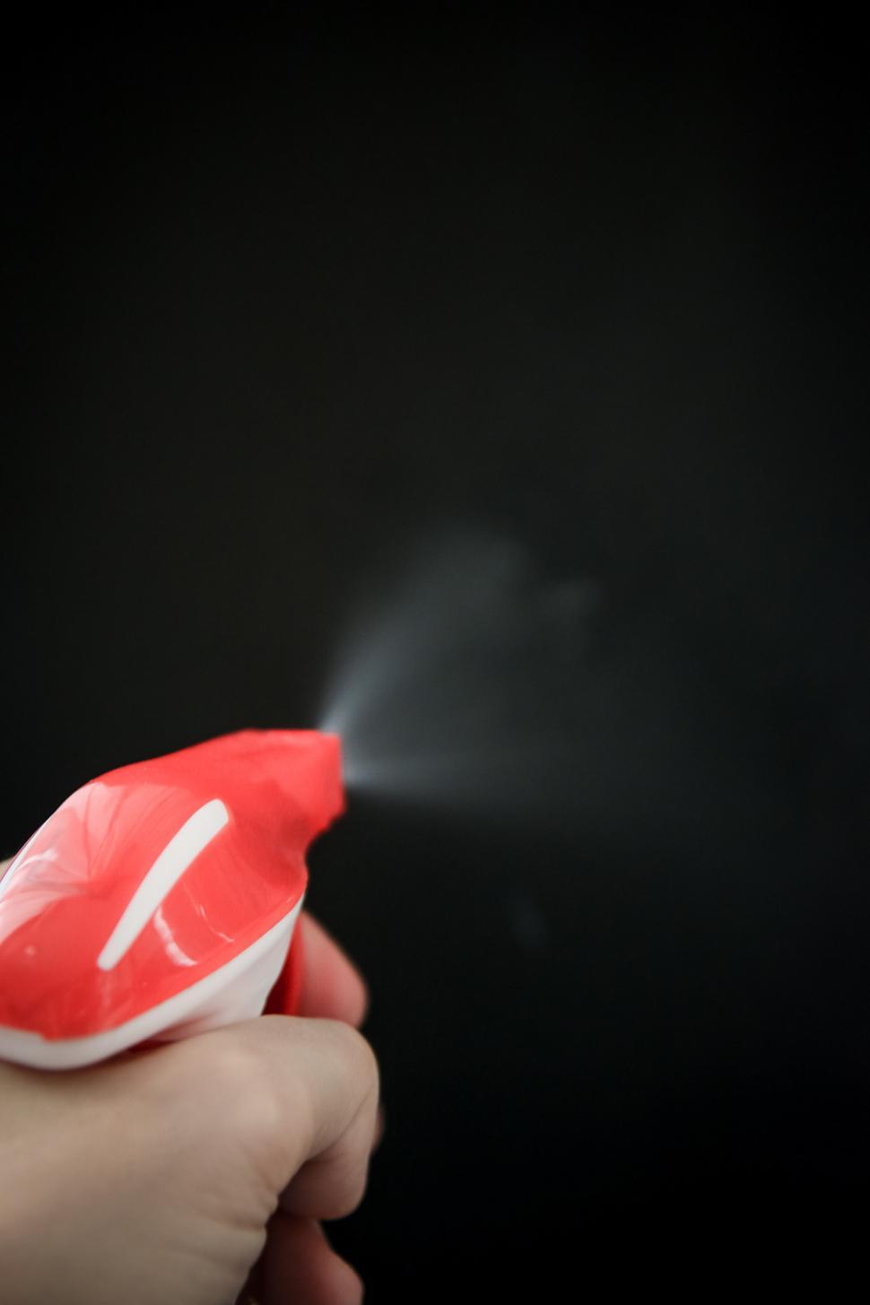 Free Image of Person Holding Red and White Object 