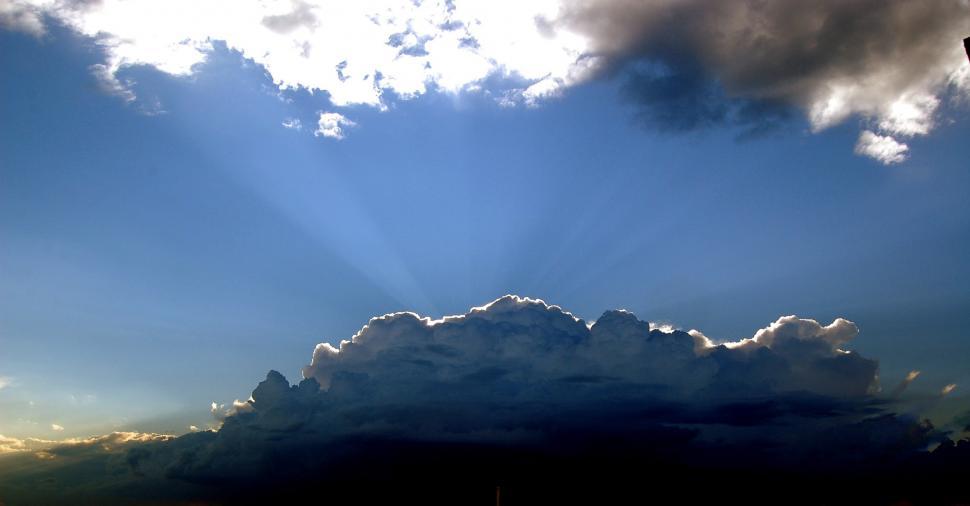 Free Image of Plane Flying Through Cloudy Blue Sky 