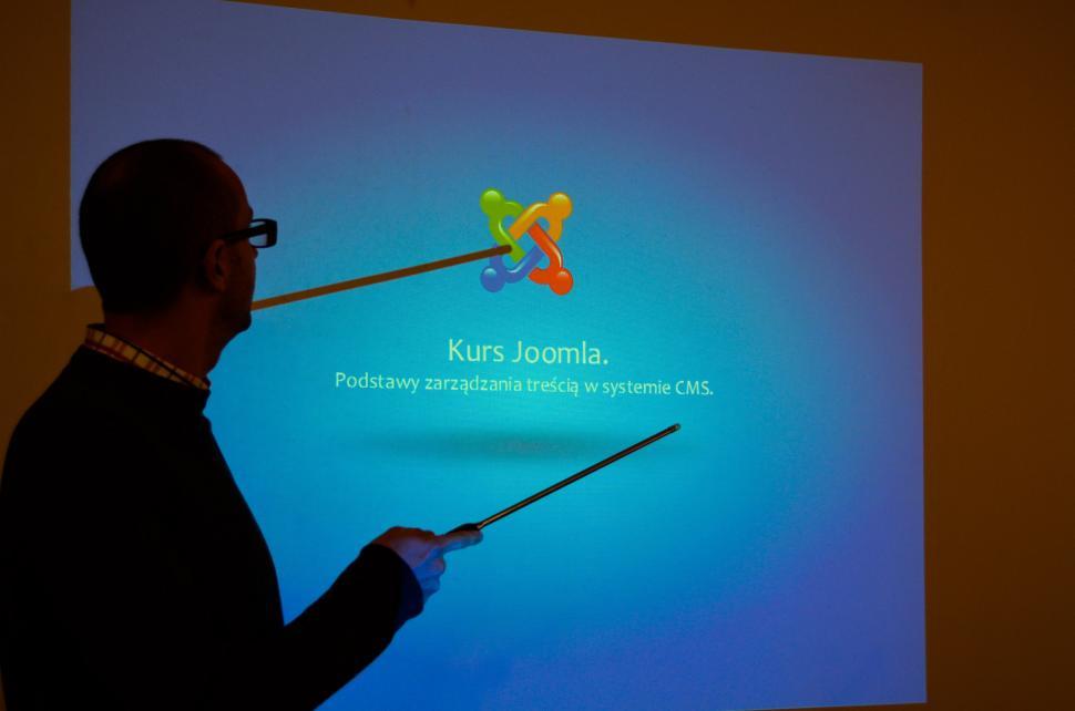 Free Image of Man Standing in Front of Projection Screen 