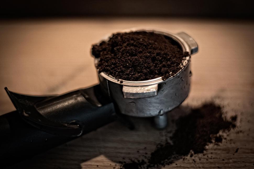 Free Image of Metal Cup Filled With Dirt on Wooden Table 