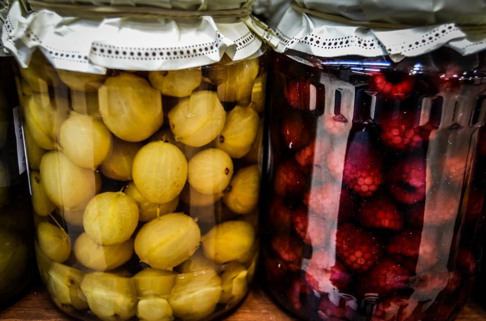 Free Image of Three Jars Filled With Pickles and Lemons on a Table 