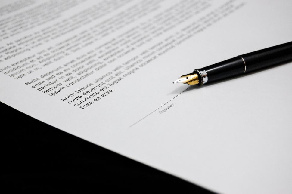 Free Image of Pen on Top of Piece of Paper 