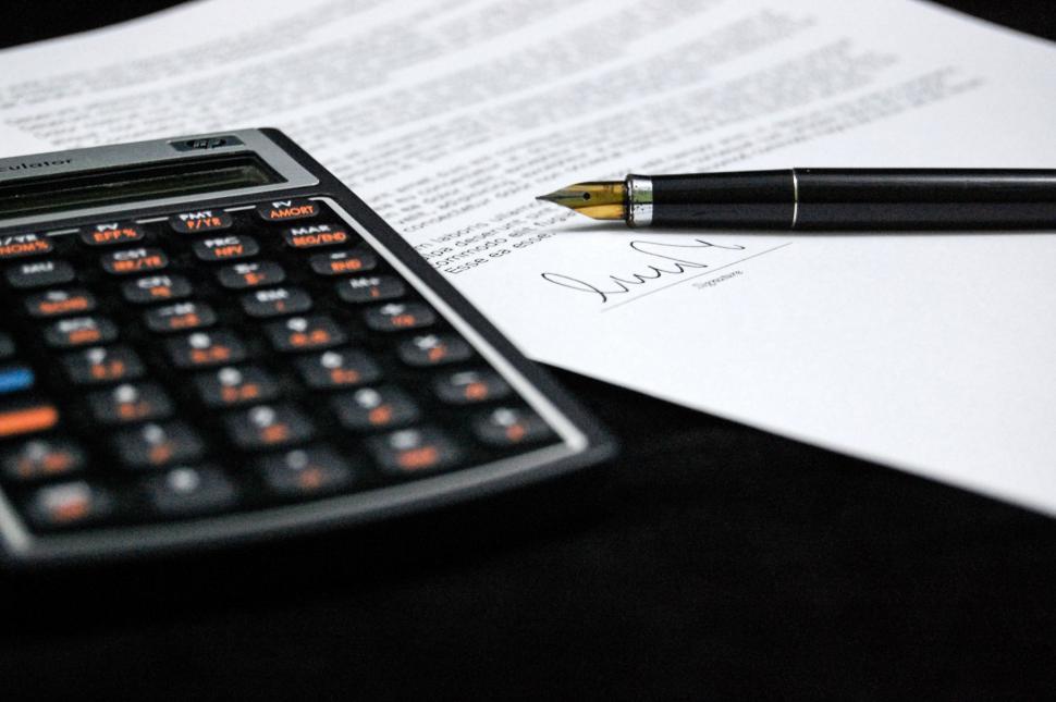 Free Image of Desk With Calculator, Pen, and Paper 