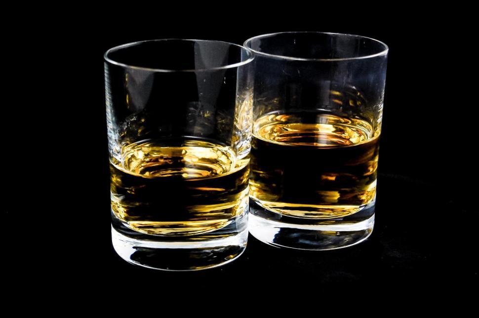 Free Image of Two Glasses of Whiskey on a Black Background 