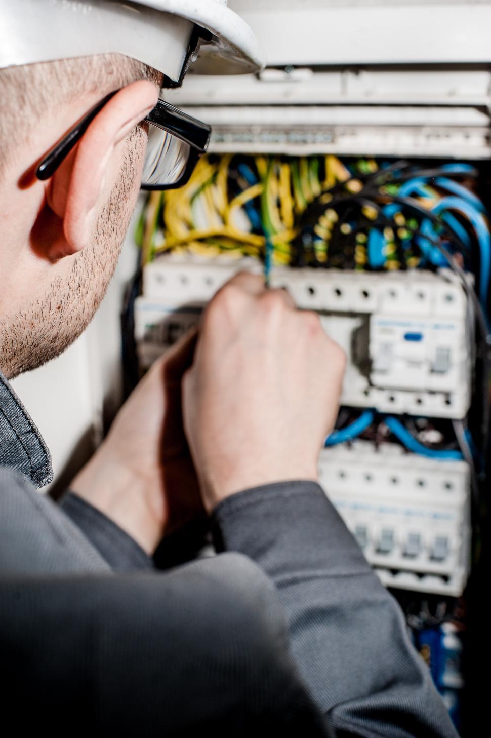 Free Image of Man in Hardhat Working on Switch Box 