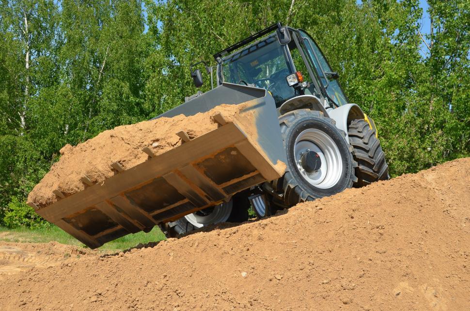 Free Image of Bulldozer Digging Through Dirt in Field 
