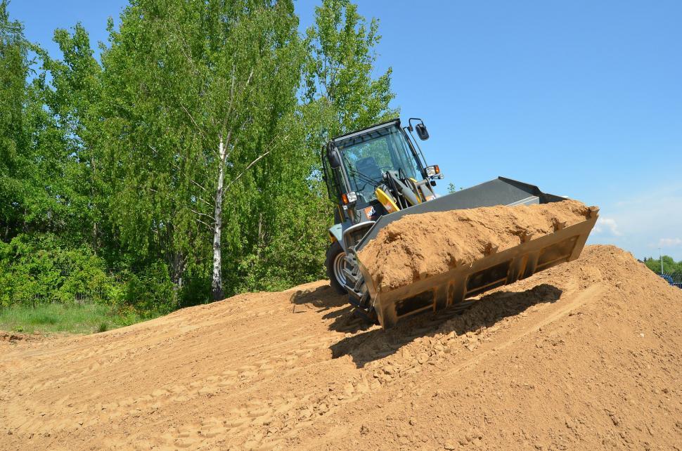 Free Image of Bulldozer Digging Through Dirt in Field 