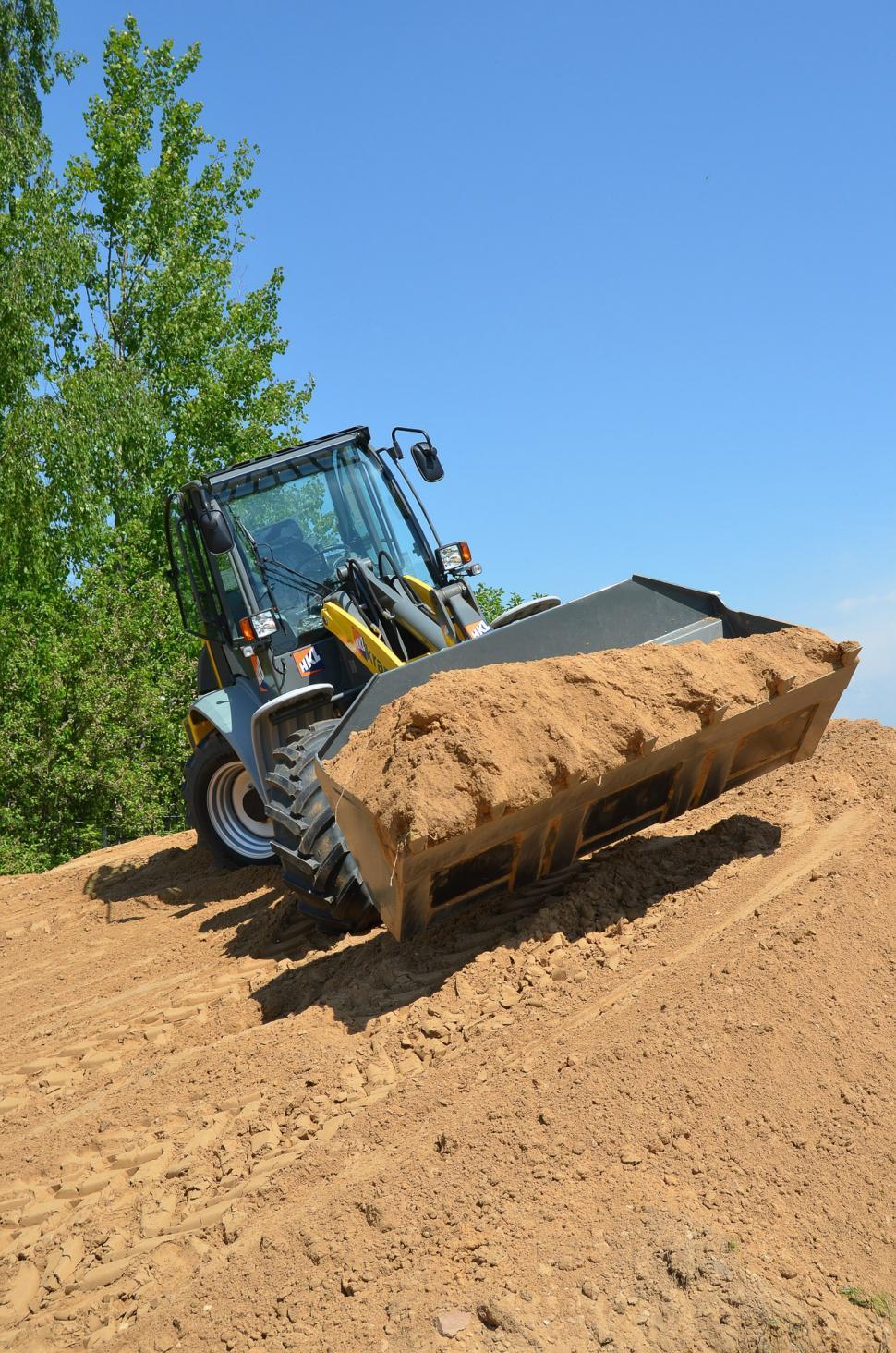 Free Image of Bulldozer Digging Through Dirt Field 