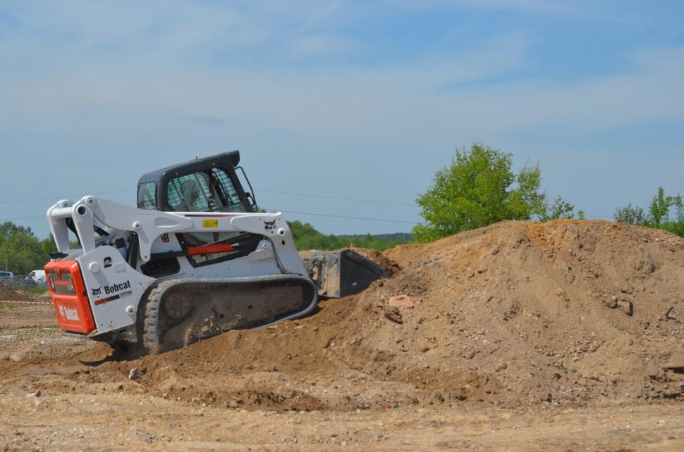 Free Image of Bulldozer Digging Through Pile of Dirt 