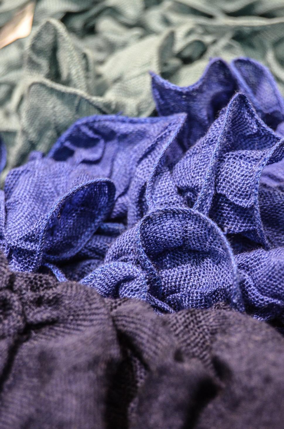 Free Image of Pile of Cloth on Bed 