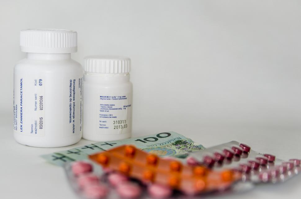 Free Image of Bottle of Pills Next to Pack of Pills 