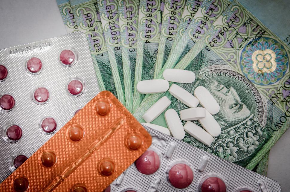 Free Image of Pile of Money and Pills Next to Pack of Pills 
