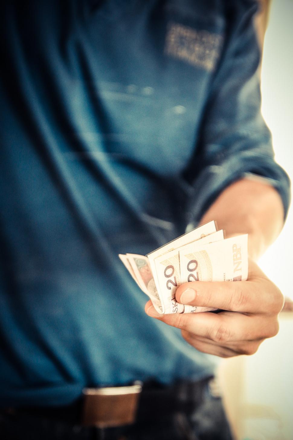 Free Image of Man Holding a Bunch of Money 