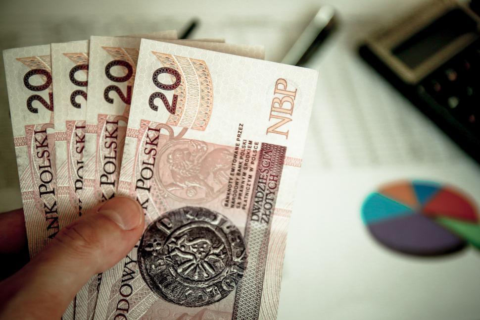 Free Image of Person Holding a Bunch of Money 