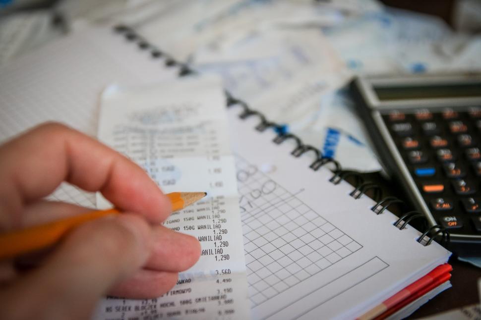 Free Image of Person Using Pencil and Calculator for Calculation 