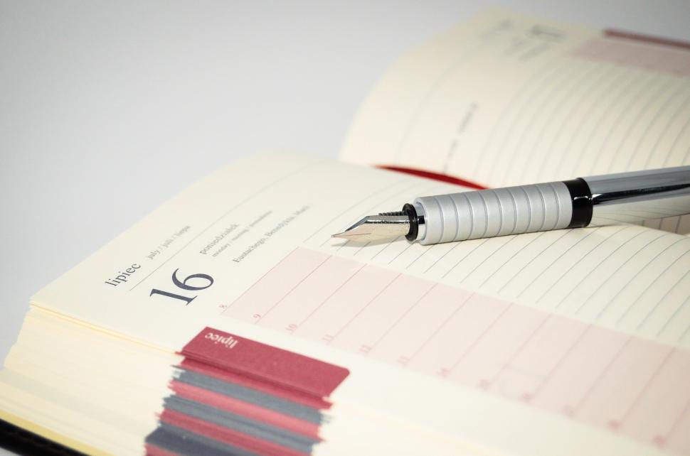 Free Image of Pen on Top of Open Notebook 