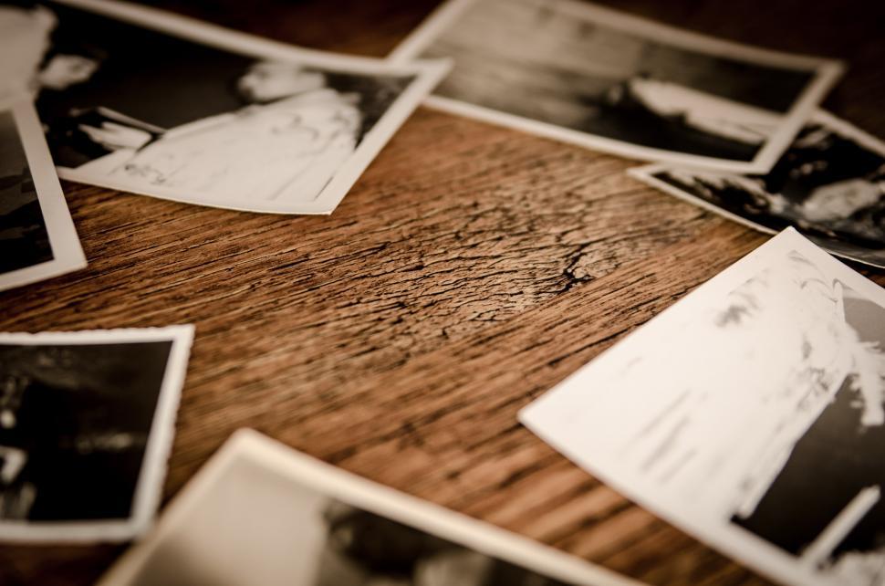 Free Image of Wooden Table Covered With Various Photos 