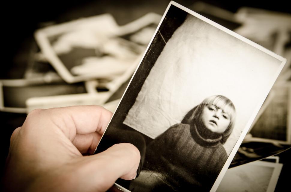 Free Image of Person Holding Up Picture of Child 