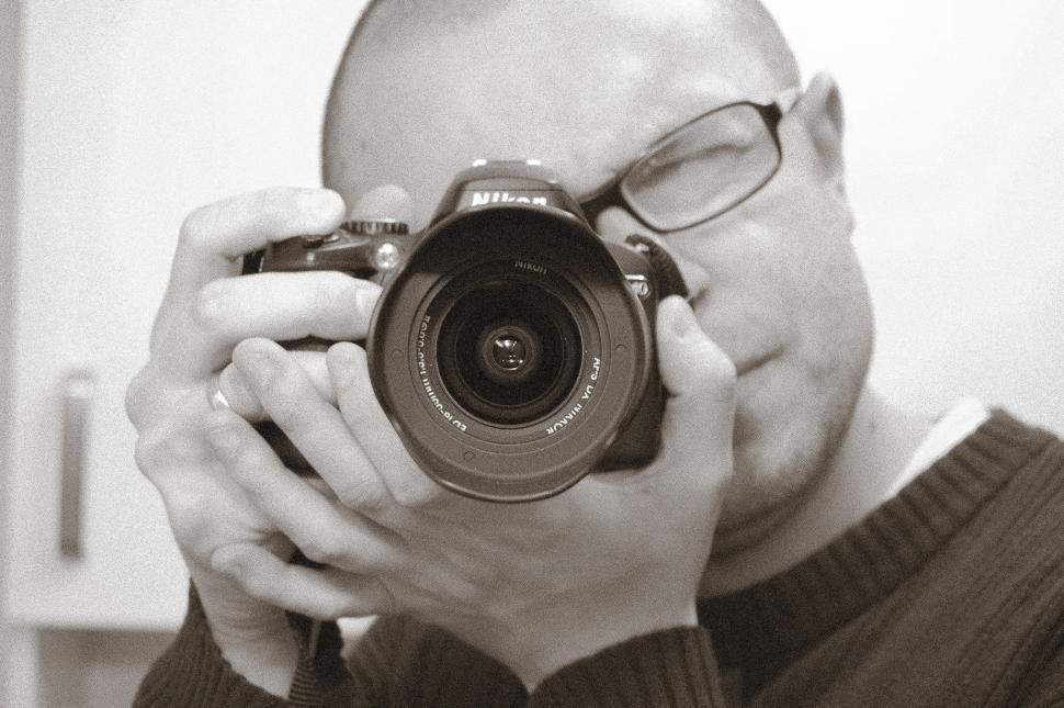 Free Image of Man Holding Camera Up to Face 