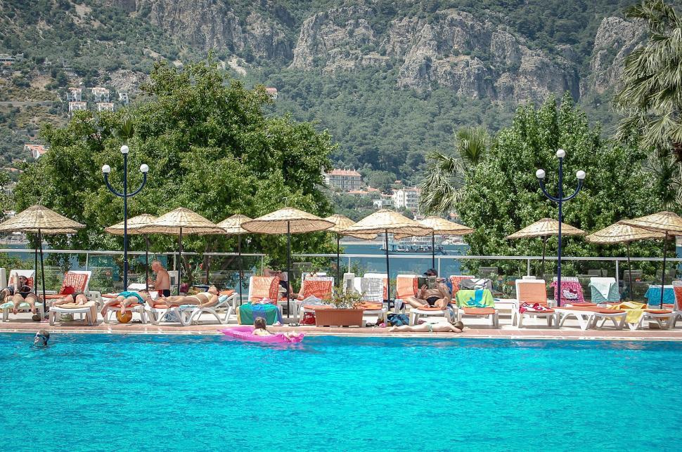 Free Image of Group of Lawn Chairs by a Swimming Pool 