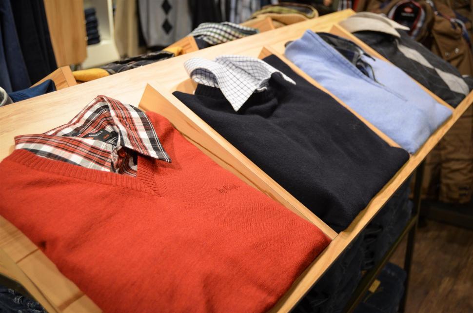 Free Image of Wooden Table Covered With Shirts 