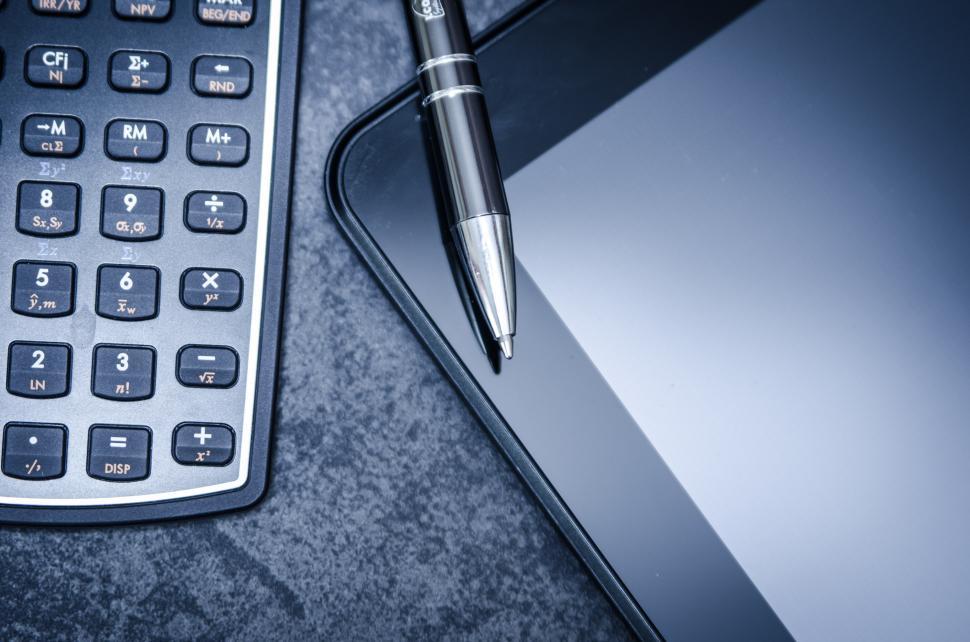 Free Image of Calculator and Pen on Table 