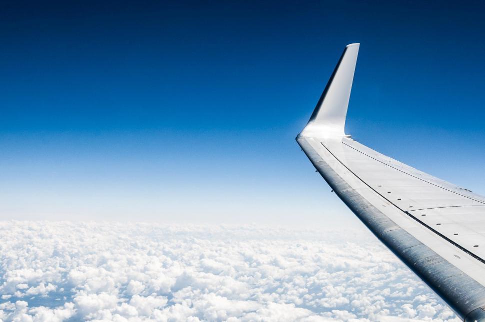 Free Image of Airplane Wing Flying Above Clouds 