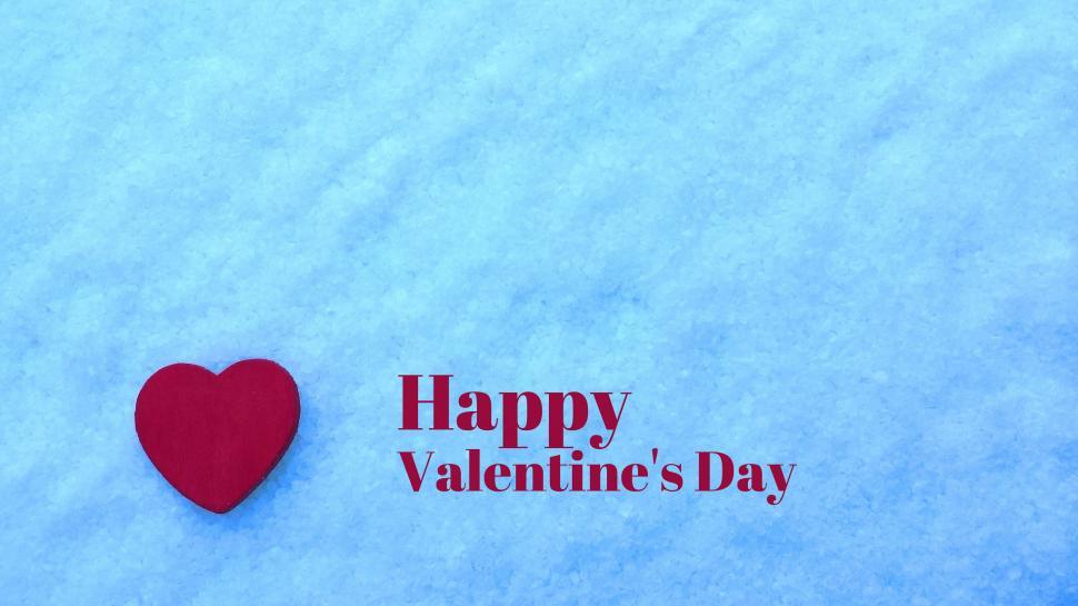 Free Image of Red Heart Resting on Snowy Ground 