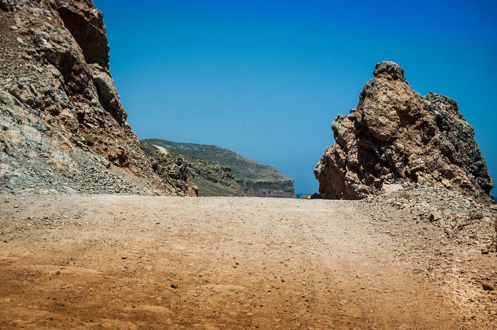 Free Image of Dirt Road Between Two Large Rocks 