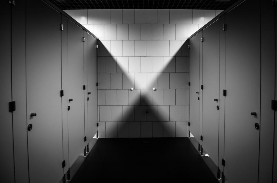 Free Image of Long Hallway With Extended Shadow on Wall 