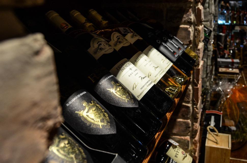 Free Image of Bottles of Wine Lined Up on Shelf 