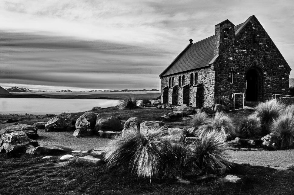 Free Image of Old house in black and white by a lake 