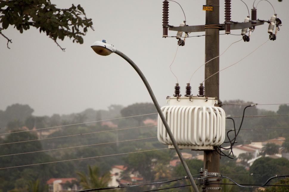 Free Image of A streetlight and transformer post in the rain 