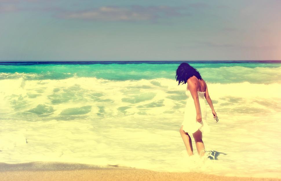 Free Image of Woman Walking Alone on the Beach - Vintage Looks 